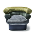 Interlude Home Leona Swivel Chair - Front View on White Background: A front-facing image of the Leona swivel chair, displaying its three-tiered design in green and gray velvet, with cylindrical armrests and a rounded back, set against a clean white background.