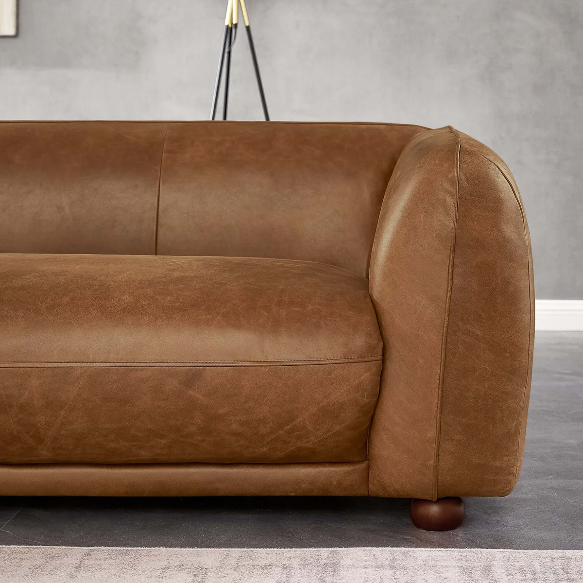 Ashcroft Marlon Luxury Italian Leather Sofa Brown positioned in a bright living room, emphasizing its luxurious and inviting look.